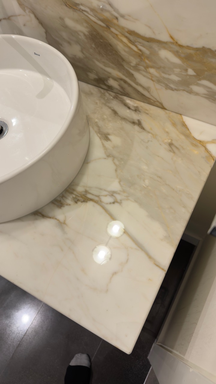 Close view of a polished protected stone vanity in Coal Harbour