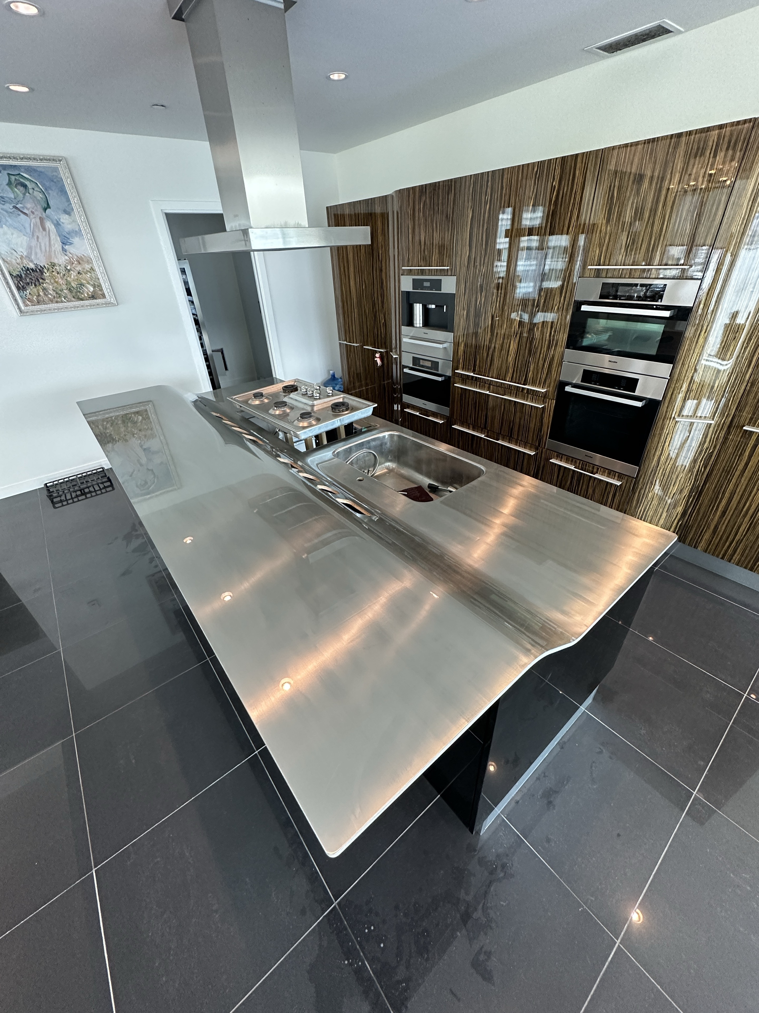 Polished protection film installed on a stainless-steel kitchen counter at Three Harbour Green in Coal Harbour, Vancouver