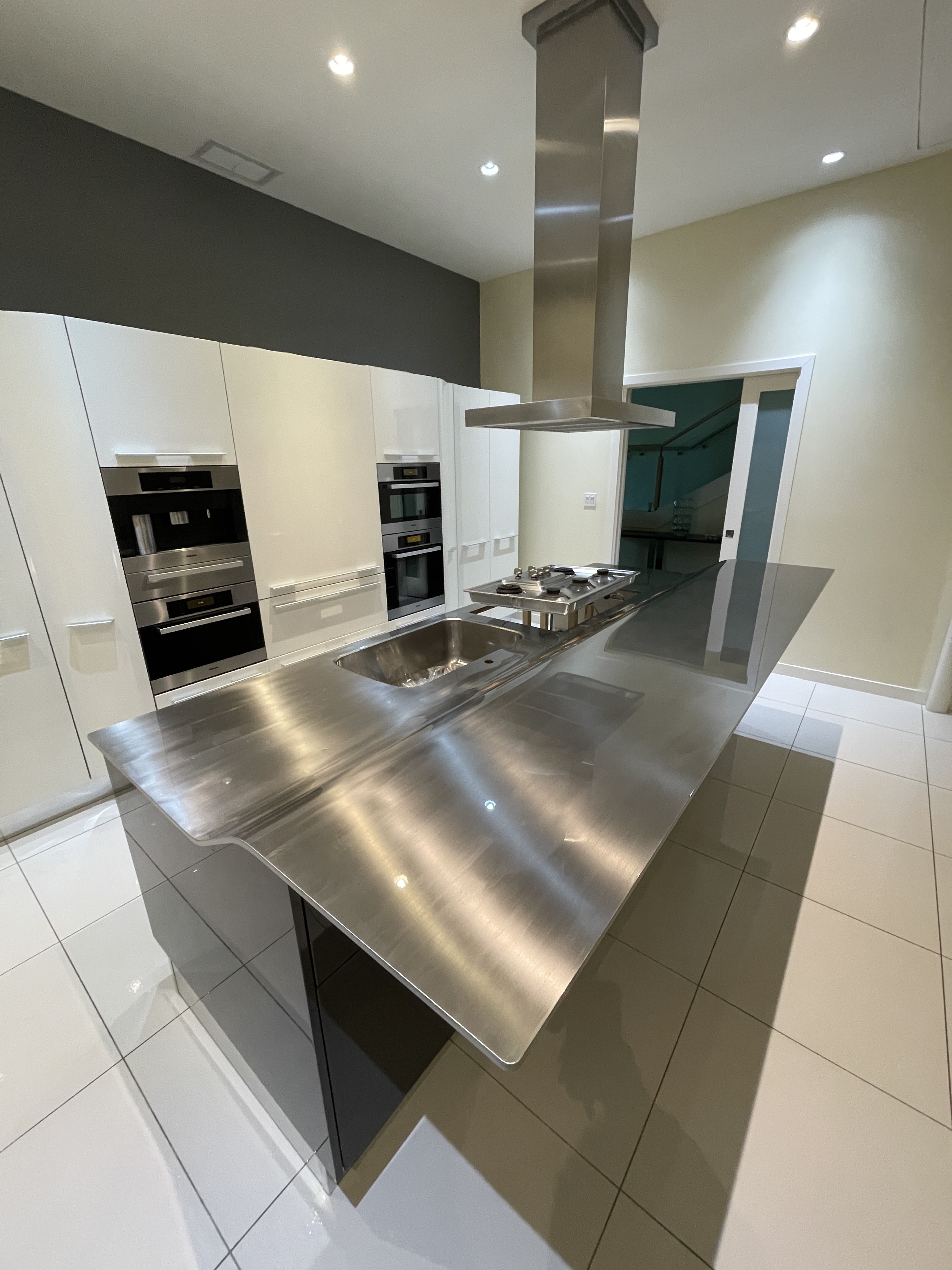 Polished protection film installed on a stainless-steel kitchen countertop at Three Harbour Green in Coal Harbour, Vancouver